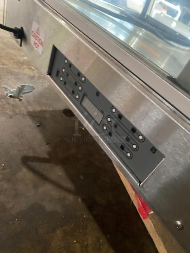 Vendo commercial stainless steel heated food merchandiser with slanted glass, rear sliding doors, and 115V control panel.