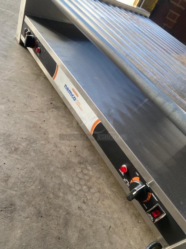 Nemco 8075SX208SP stainless steel hot dog roller grill, 75-dog capacity, non-stick rollers, electric, on legs.