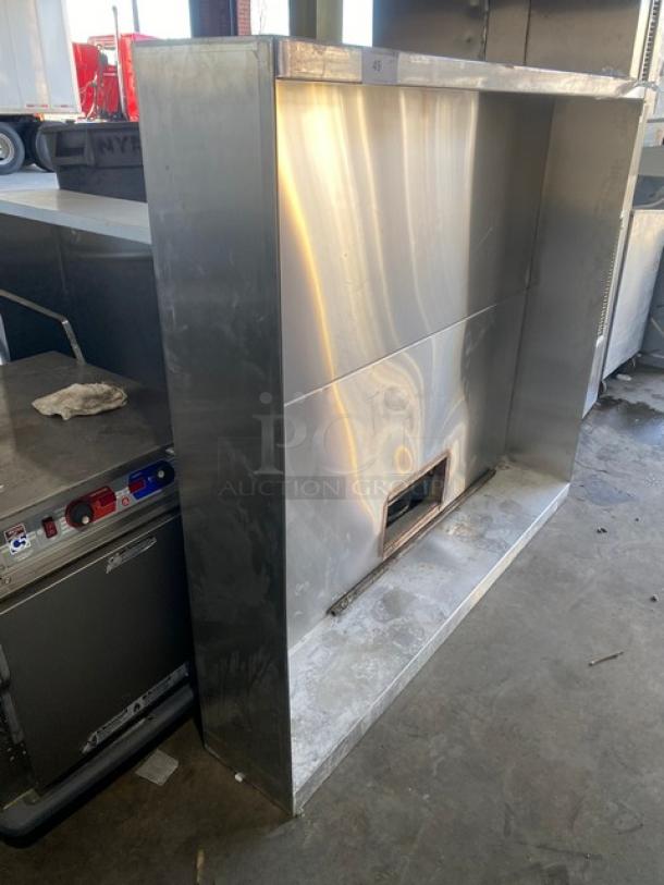 Commercial stainless steel kitchen exhaust hood, large, with vent, polished finish, minor scratches, suitable for professional kitchens.