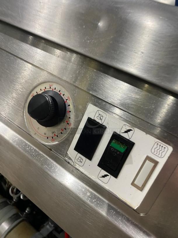 Fry Master FMP145ESC stainless steel 2-bay deep fat fryer control panel, features dials and switches, natural gas powered.