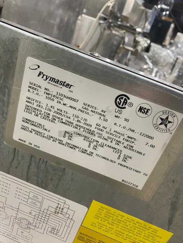 Fry Master commercial stainless steel gas fryer, model FMP145ESC, with basket hanger, fry baskets, filtration system, and casters.