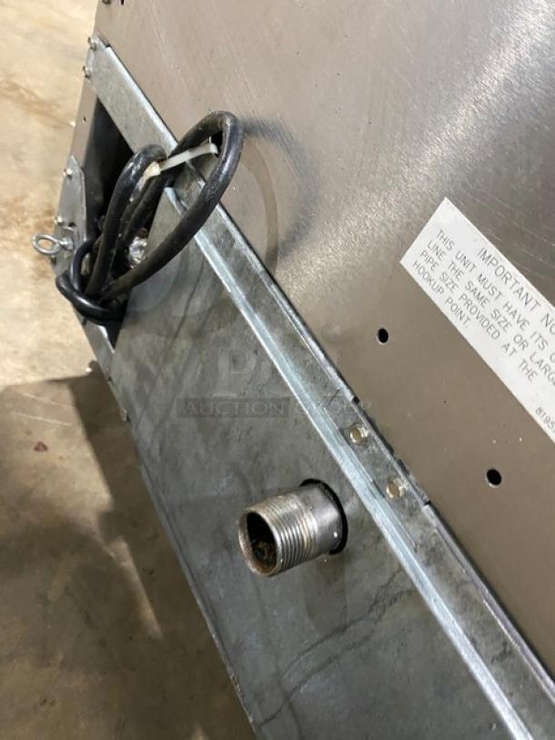 Fry Master FMP145ESC stainless steel 2-bay deep fat fryer back view showing power cord, filtration system connection, and label indicating model and power requirements.