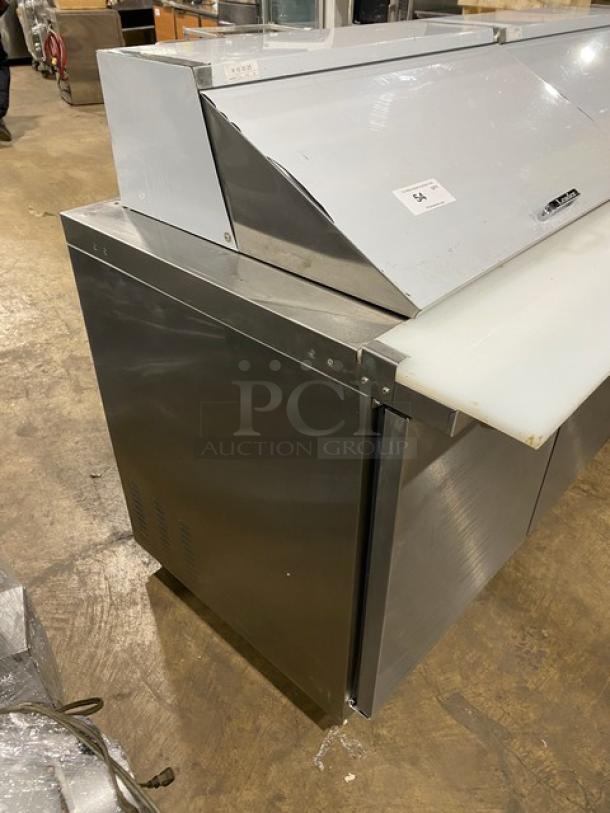 Kool-It Ikon Series 3-door stainless steel refrigerated prep table, model KSP72M, with cutting board and wired rack, on casters.