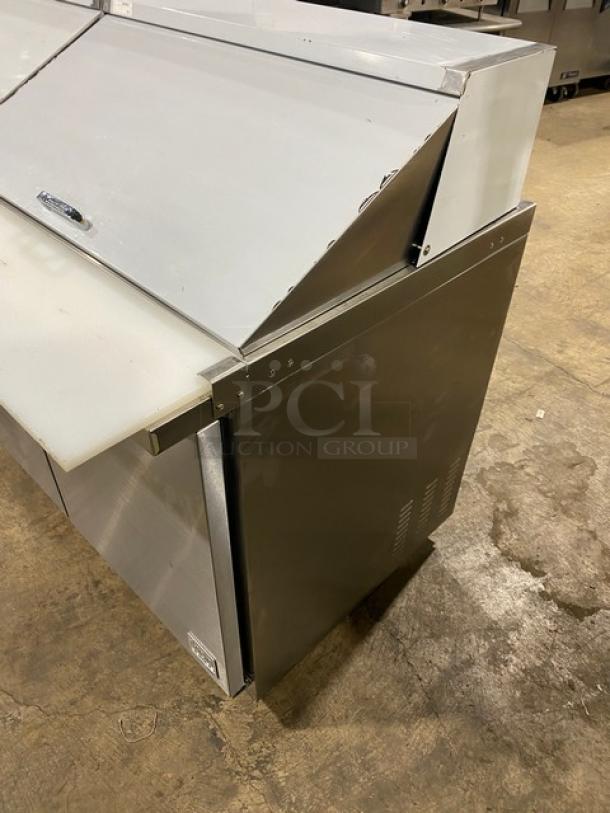 Kool-It Ikon Series 3-Door Refrigerated Prep Table, stainless steel, with cutting board, Model KSP72M, on casters.