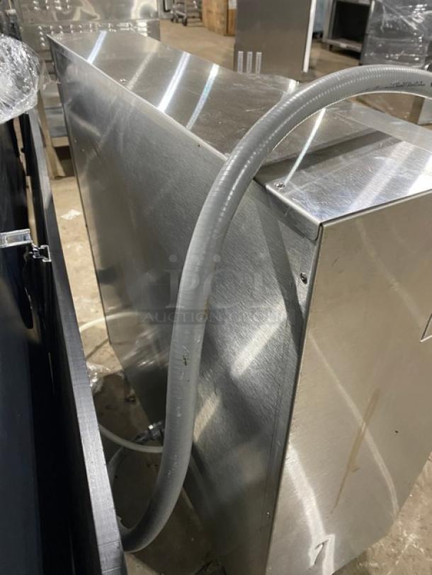 Fetco CBS-62H stainless steel 3-gal. twin coffee brewer. Electric-powered, countertop, with hoses attached.