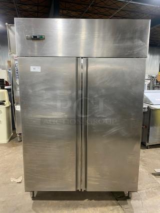 Commercial stainless steel 2-door reach-in refrigerator on legs with poly-coated wire rack, digital controls, excellent condition.