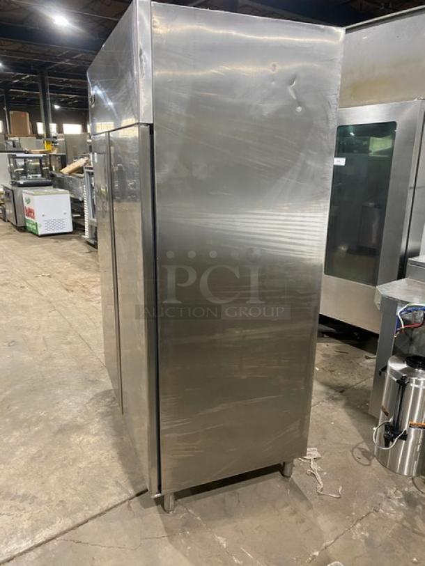 Commercial stainless steel 2-door reach-in refrigerator with poly-coated wired rack, on legs, in good condition.