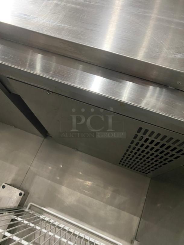 Commercial stainless steel 2-door reach-in refrigerator, features poly-coated wire rack, on legs, clean condition.