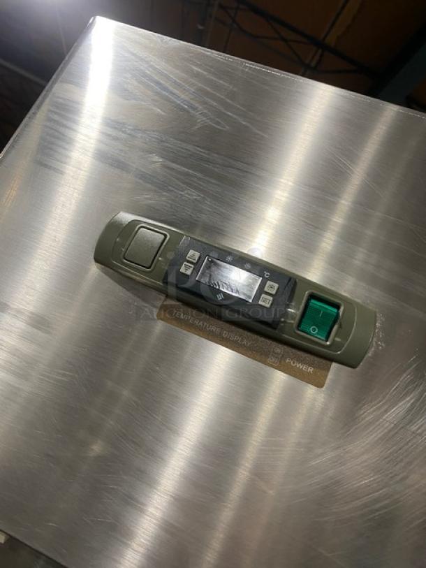 Commercial stainless steel 2-door reach-in refrigerator with poly-coated wire rack, digital display, and sturdy legs.