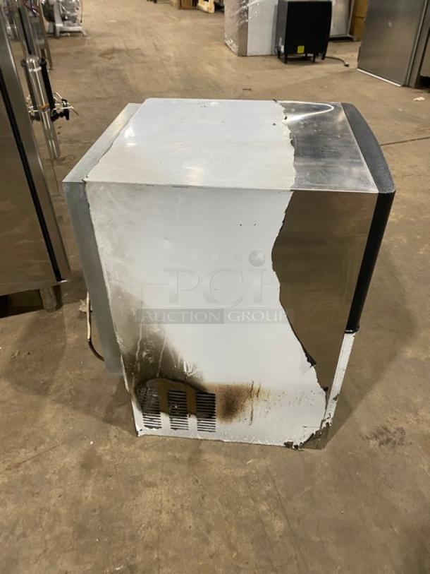 Spartan SUIM-120-HC ice machine, stainless steel, electric, air-cooled, undercounter model. Visible wear and discoloration on surface.