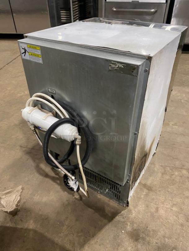 Stainless steel Spartan SUIM120HC ice maker, 2020 model, air-cooled, undercounter design, electric-powered, visible hoses attached.