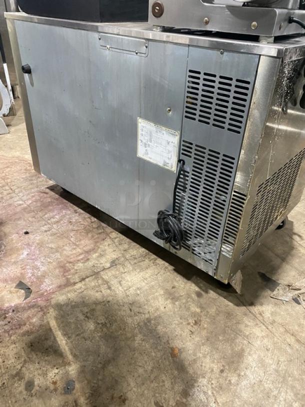 Everest ETR2 commercial stainless steel 2-door undercounter refrigerator on casters, with poly-coated wire rack. Model info visible.