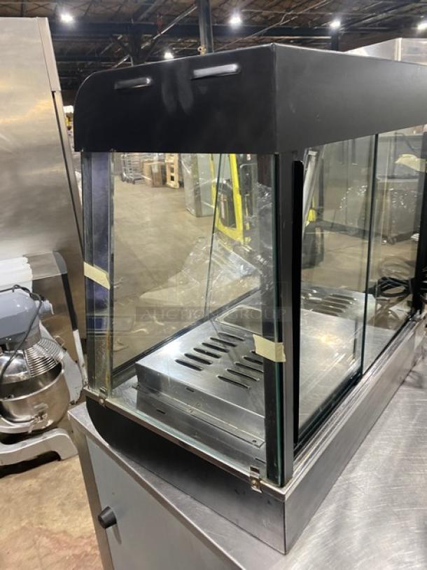 Commercial black slanted glass countertop heated display case, model FW-2-2, with stainless steel interior, 110V 1 Phase.