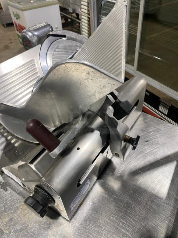 Globe Commercial Electric Countertop Knife Feed Deli Meat Slicer on legs, features adjustable blade, metallic finish, good condition.