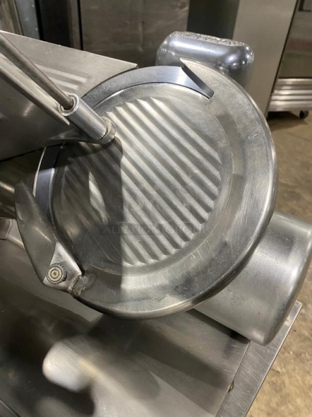 Globe commercial electric countertop deli meat slicer on legs, metal blade visible, sturdy, used condition.