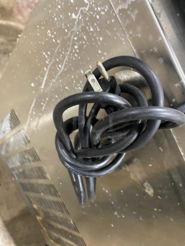 Globe commercial electric countertop deli meat slicer cord detail, showing power plug.