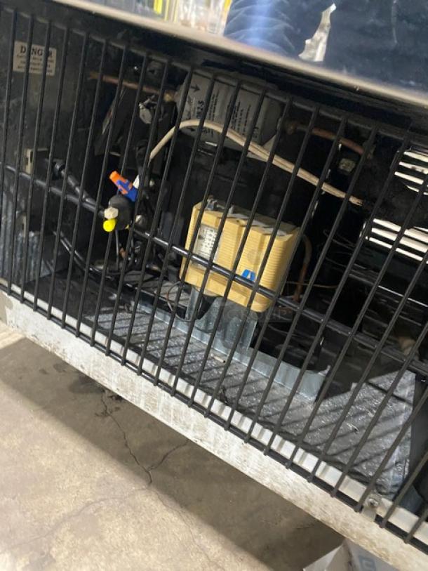 Marc SQBCR59 bakery display case underside showing electrical components and wiring, with vented design for proper cooling.