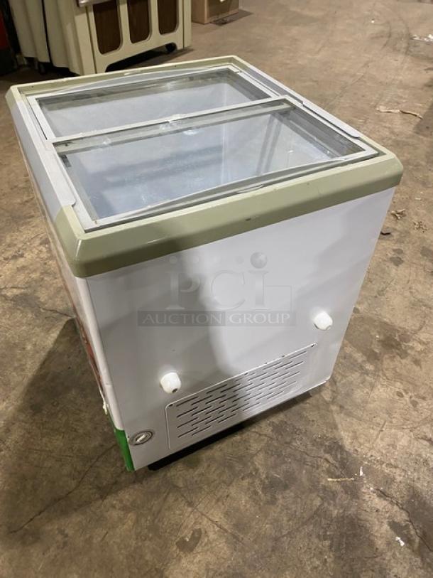 Commercial 28" white Brooklyn Eatz ice cream merchandiser with dual sliding glass lid, 110V, on casters.