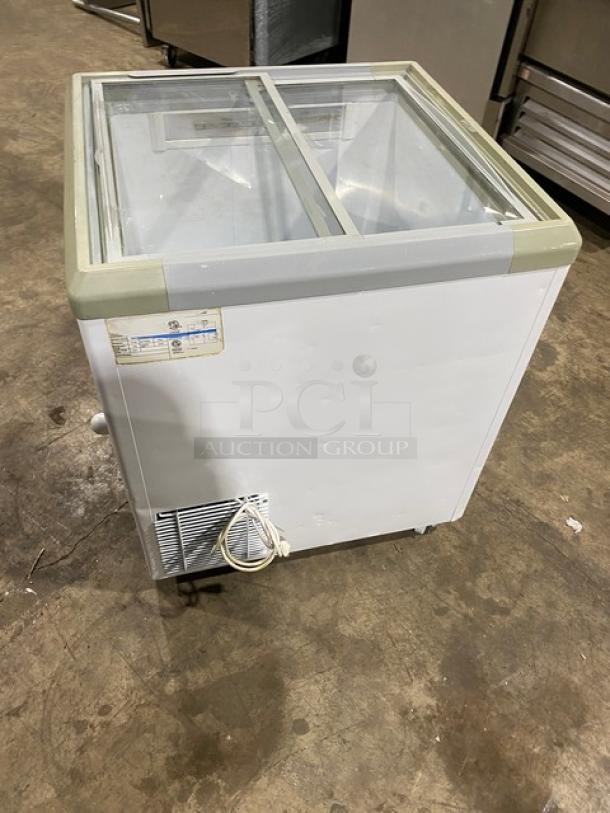 Commercial white Brooklyn Eatz 28" display freezer; dual sliding glass lid, 110V, on casters, good condition.
