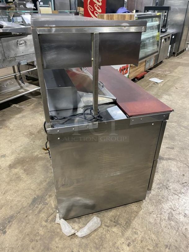 Delfield stainless steel 4-drawer refrigerated prep table, model UCD446N12DD5, with overhead storage. 115V, used condition.