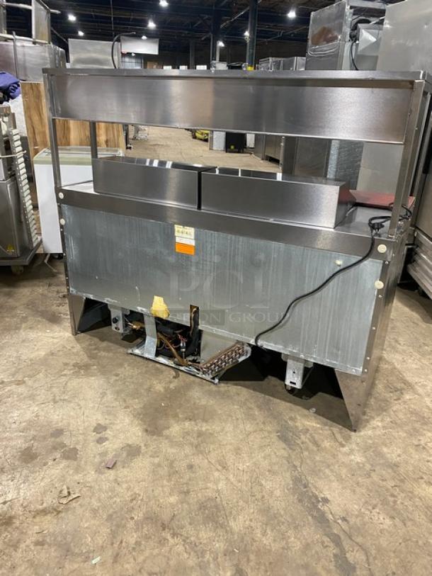 Delfield stainless steel refrigerated prep table, Model UCD446N12DD5, with 4 drawers, overhead storage, visible power cord.