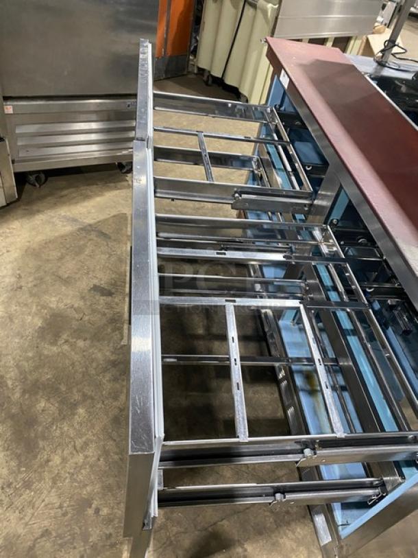 Delfield UCD446N-12-DD5 stainless steel 4-drawer refrigerated prep table, bain marie style, with overhead storage.