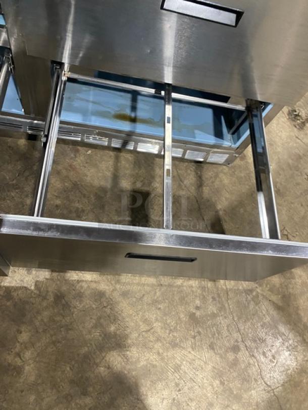 Delfield stainless steel 4-drawer refrigerated prep table, model UCD446N-12-DD5. Features open drawer, sturdy build.