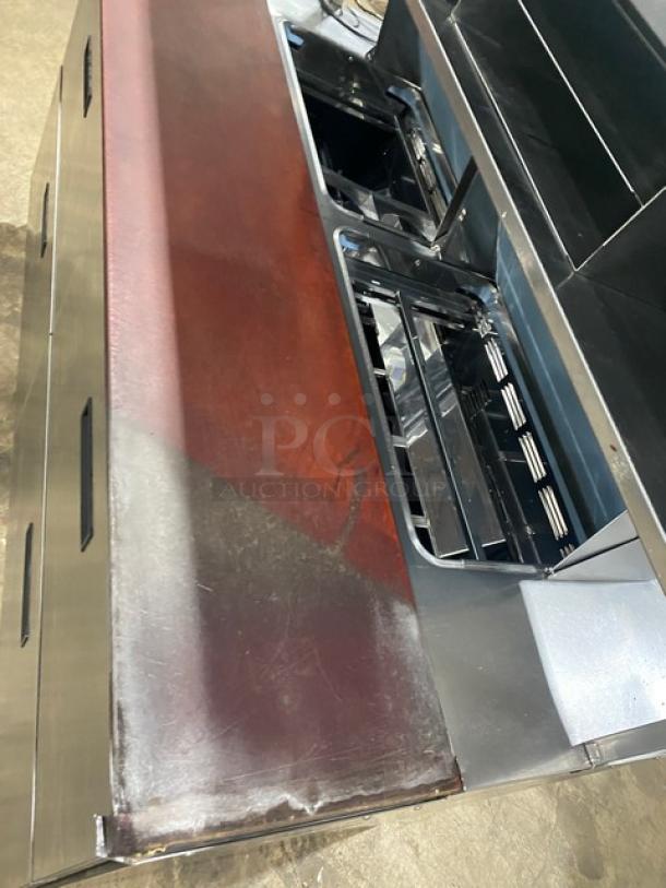 Delfield stainless steel refrigerated 4-drawer prep table, Model UCD446N-12-DD5, with overhead storage shelf, 115V, used condition.