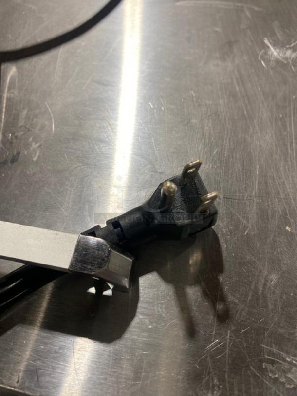 Power cord of Atosa MSF8305GR refrigerated prep table, showing three-prong plug. Stainless steel surface visible.