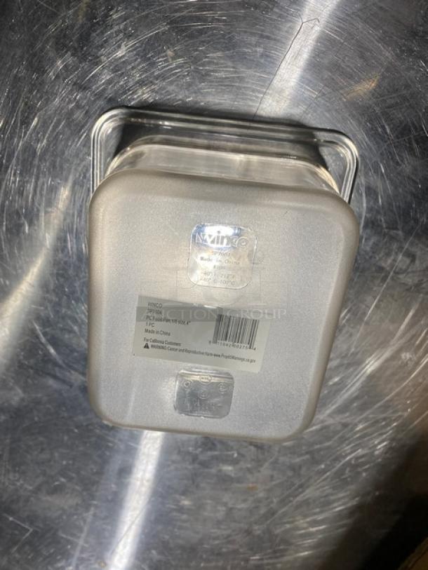 Winco SP7604 clear polycarbonate food pan, 1/6 size, 4" deep, new condition. Labels show model and material details.
