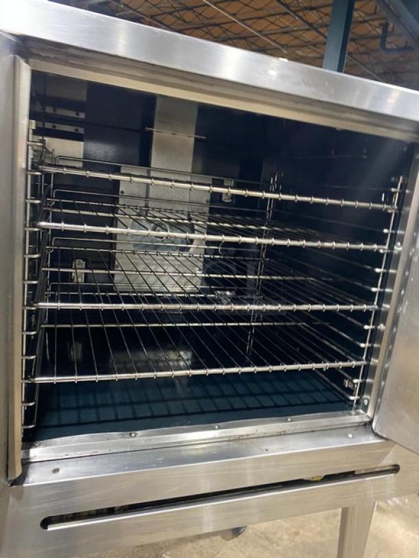 Imperial stainless steel gas convection oven, single stack, with wired oven rack, on casters. Excellent condition.