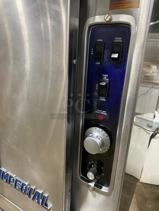 Imperial stainless steel gas convection oven, single stack, with wired rack and casters. Features control panel with lighted indicators.