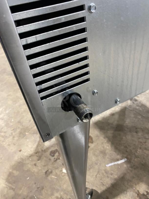 Imperial commercial stainless steel gas convection oven with vented side, gas connector, on casters.