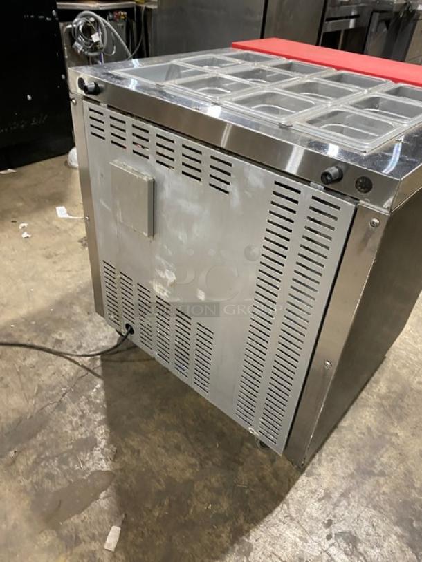 Continental SW32-12M refrigerated prep table with stainless worktop, red cutting board, and clear food pans. In good condition.