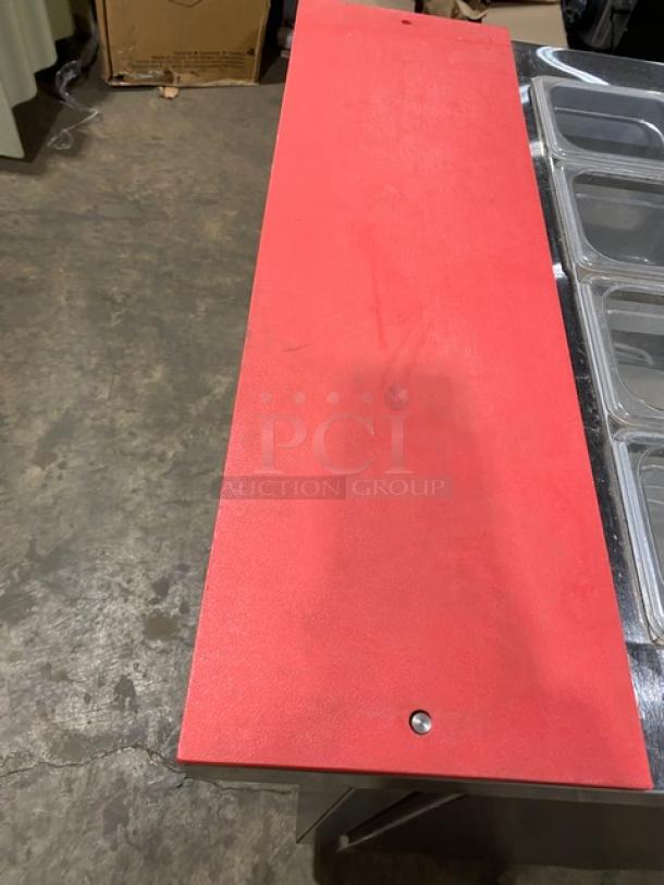 Continental SW3212M refrigerated prep table with red cutting board, clear food pans, and poly-coated wire rack on casters.