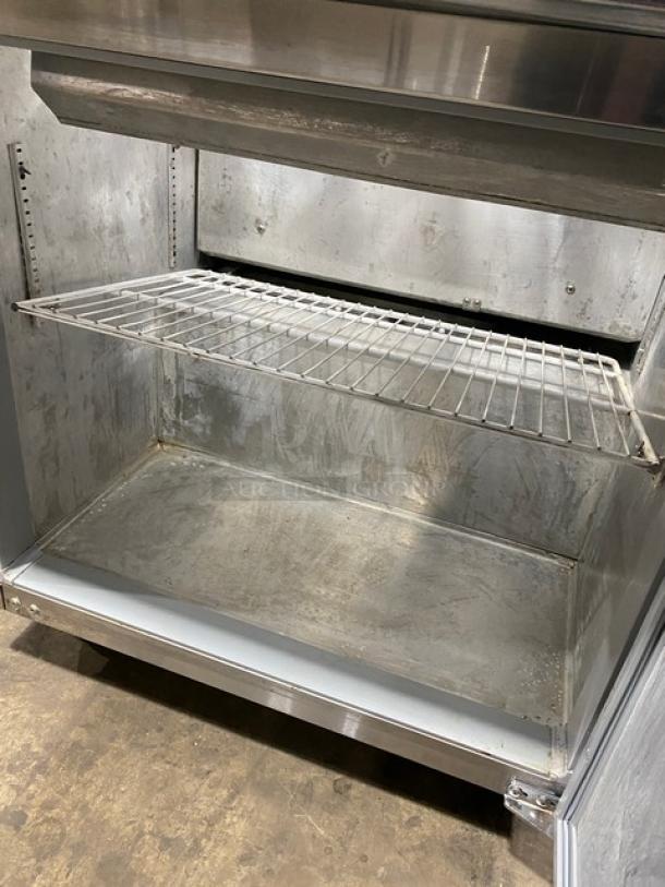 Continental SW3212M refrigerated prep table interior with poly-coated wired rack and stainless steel finish.
