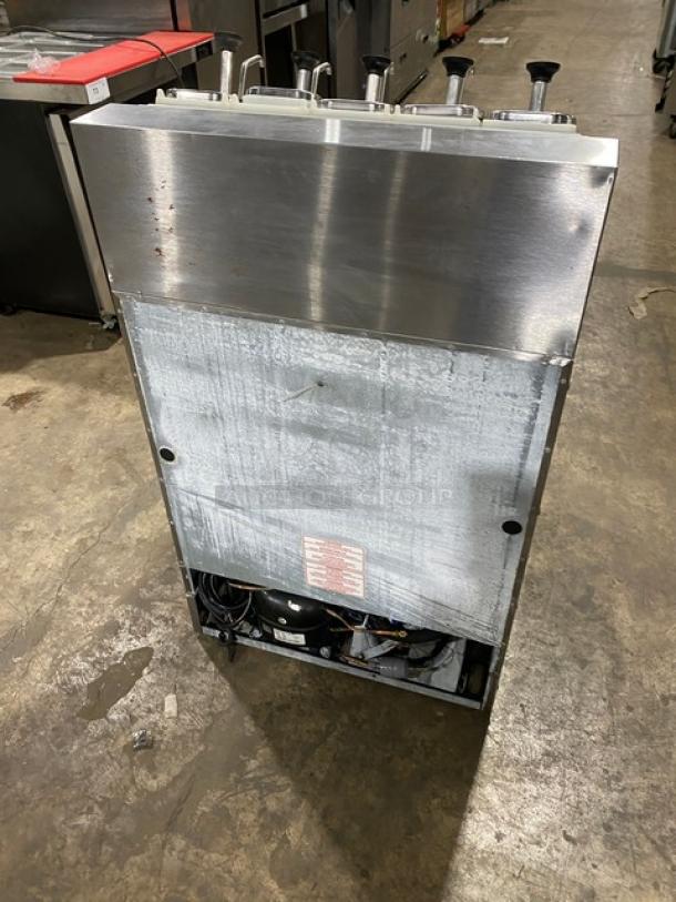 Silver King SKF2A stainless steel refrigerated ice cream topping dispenser with pumps and poly-coated rack. Model SN: SAEC42273A.