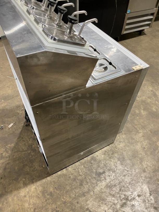 Silver King SKF2A stainless steel refrigerated dispenser with pumps, poly coated rack, great condition, model SN: SAEC42273A.