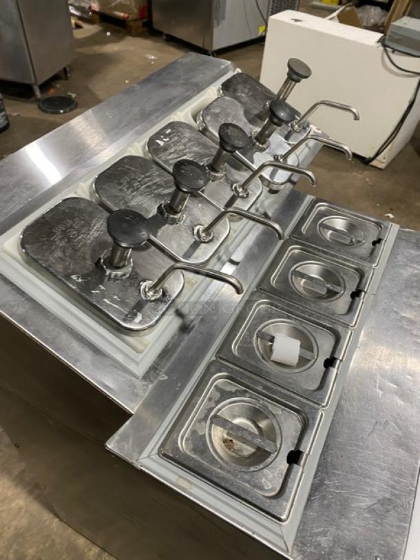 Silver King SKF2A refrigerated ice cream topping dispenser with stainless steel body, dispenser pumps, and poly-coated wire rack.