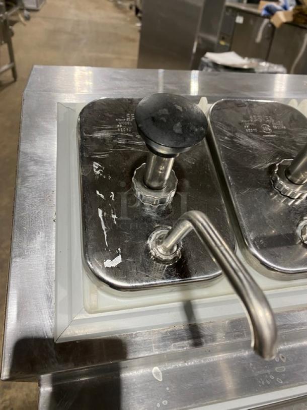 Silver King Model SKF2A stainless steel ice cream topping dispenser with pumps and poly-coated rack. Serial: SAEC42273A.