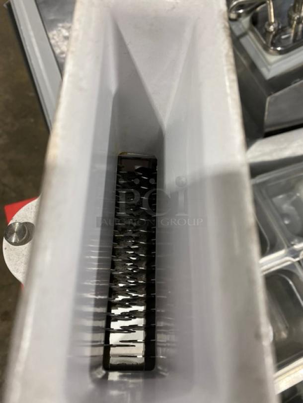 Weston Commercial White Cast Aluminum Manual Meat Cuber/Tenderizer with crank bar, in used condition, close-up of blades.