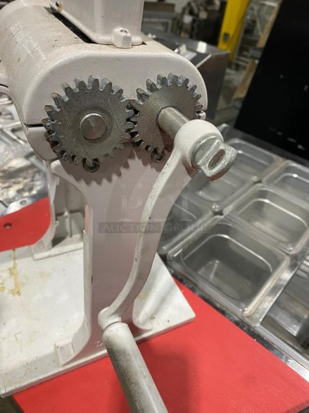 Weston commercial white cast aluminum manual meat cuber/tenderizer with crank bar, in used condition, visibly sturdy gears.