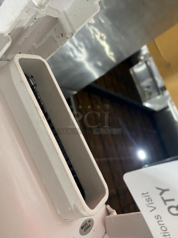 Weston Commercial white cast aluminum meat cuber/tenderizer, manual with crank bar, countertop model, "Made in China" marking.