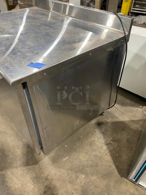 Traulsen 48" stainless steel undercounter quick chiller model TU048QC, features backsplash, poly-coated rack, on casters.