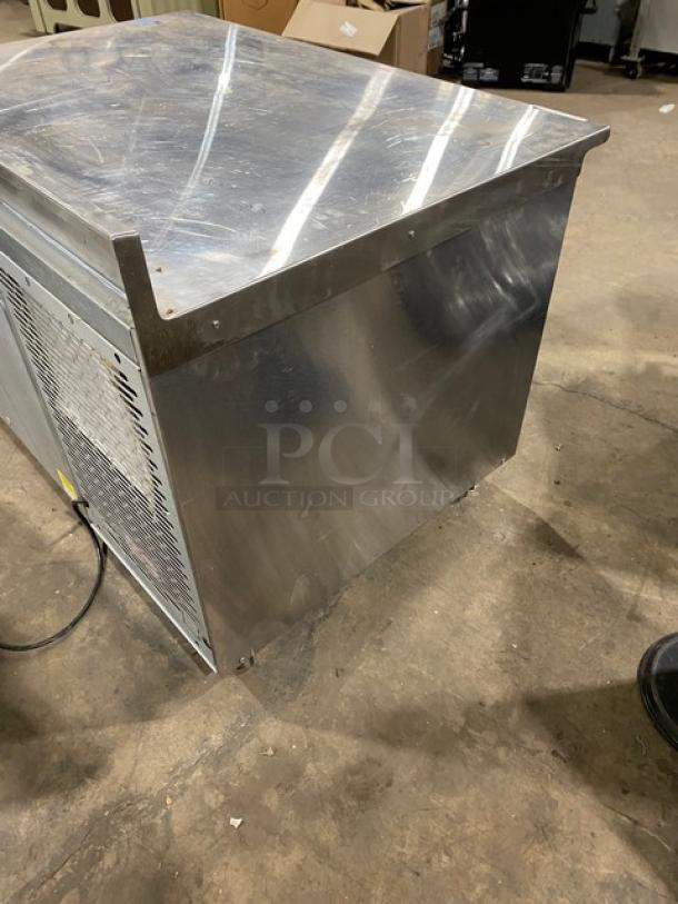 Traulsen stainless steel single door undercounter blast chiller, Model TU048QC, with back splash and poly-coated rack, on casters.