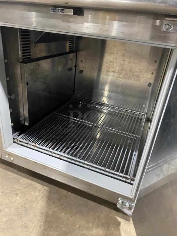Traulsen TU048QC stainless steel 48" single-door undercounter chiller with poly-coated wire rack, backsplash, on casters.