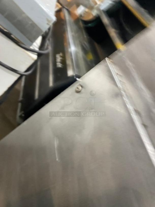 Traulsen TU048QC commercial stainless steel single door undercounter quick chiller with backsplash, on casters.