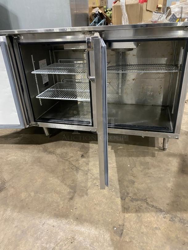 GlasTender LP60L6SSLL stainless steel 2-door back bar cabinet, 60", with poly coated racks, shown open, on legs.