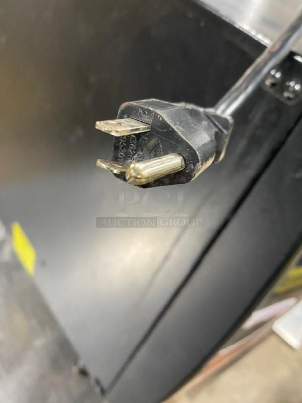 Bunn LCC2LP commercial liquid coffee dispenser, dual-flavor, hot water feature, 120V, on legs, black, electric plug shown.