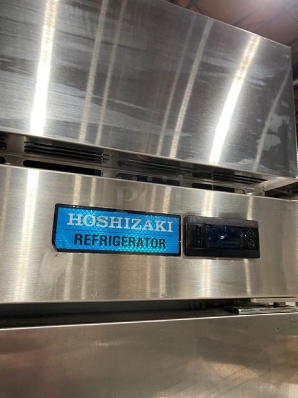 Hoshizaki R2A-FS commercial stainless steel 2-door refrigerator with poly-coated wire rack, model label visible, on casters.
